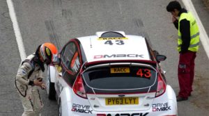 Rally car number 43 with driver and co-driver preparing for race.