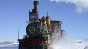 A vintage steam locomotive emitting steam.