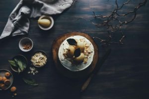 A rustic table with a cup of coffee and ingredients for baking.