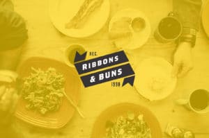 A yellow-tinted image of breakfast with pancakes, eggs, and drinks.