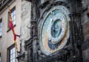 Close-up of an ornate historic astronomical clock on a stone building.