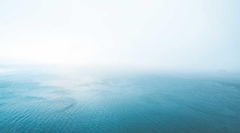 A serene ocean view with a soft gradient sky.