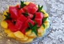 Colorful fruit plate with watermelon and mango slices.