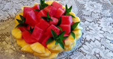 Colorful fruit plate with watermelon and mango slices.