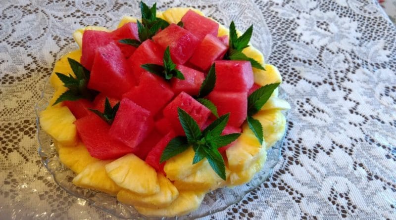 Colorful fruit plate with watermelon and mango slices.