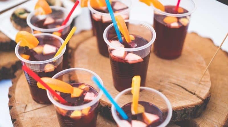 Cold drinks with ice and colorful straws in clear cups.