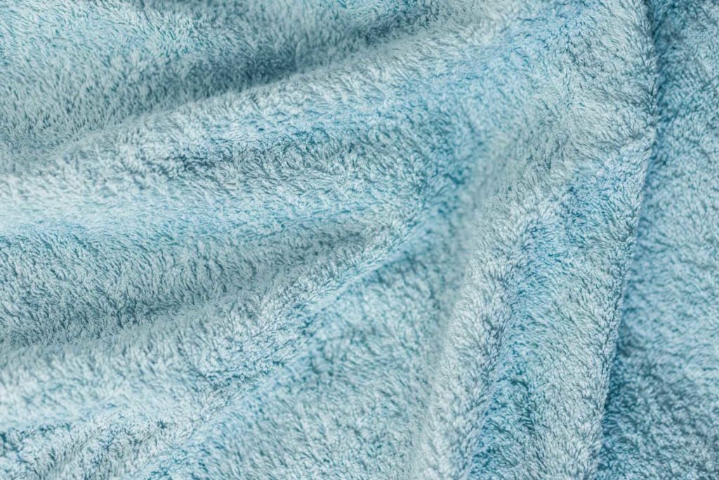 Close-up of soft, light blue fabric texture.