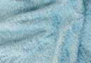 Close-up of soft, light blue fabric texture.