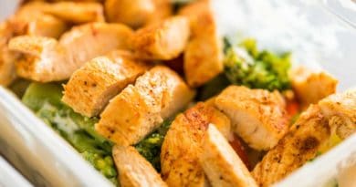 Sliced seasoned chicken breast with sides of fries and guacamole.