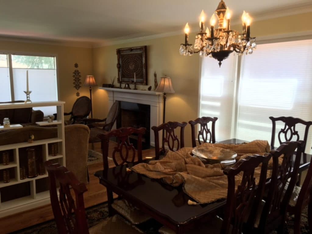 Cozy dining room with wooden furniture and warm lighting.