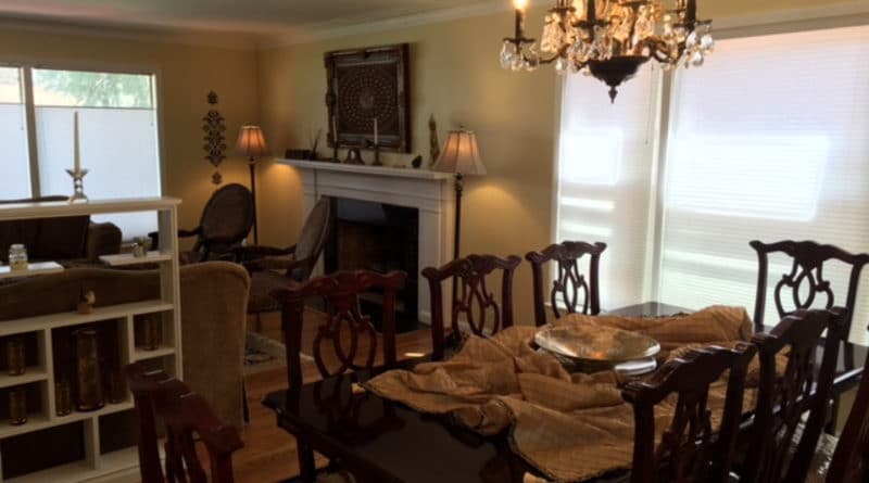 Cozy dining room with wooden furniture and warm lighting.