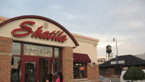 Exterior view of Chevalla restaurant with a water tower in the background.