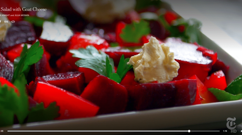 Close-up of beet salad with creamy dressing and parsley garnish.