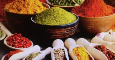Colorful spices displayed in bowls and spoons.