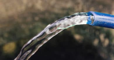 Clear water flowing from a plastic bottle.
