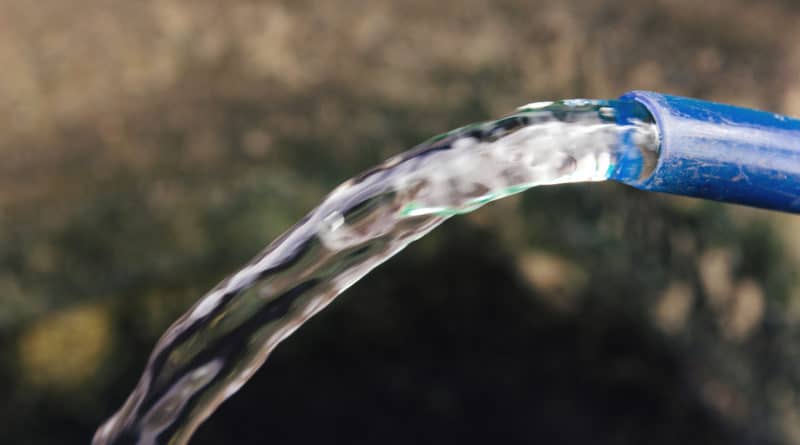 Clear water flowing from a plastic bottle.