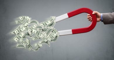 A horseshoe magnet attracting dollar bills.