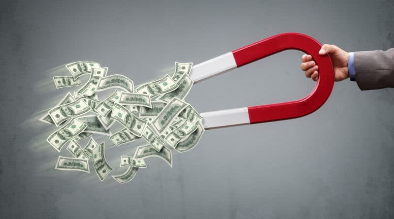 A horseshoe magnet attracting dollar bills.