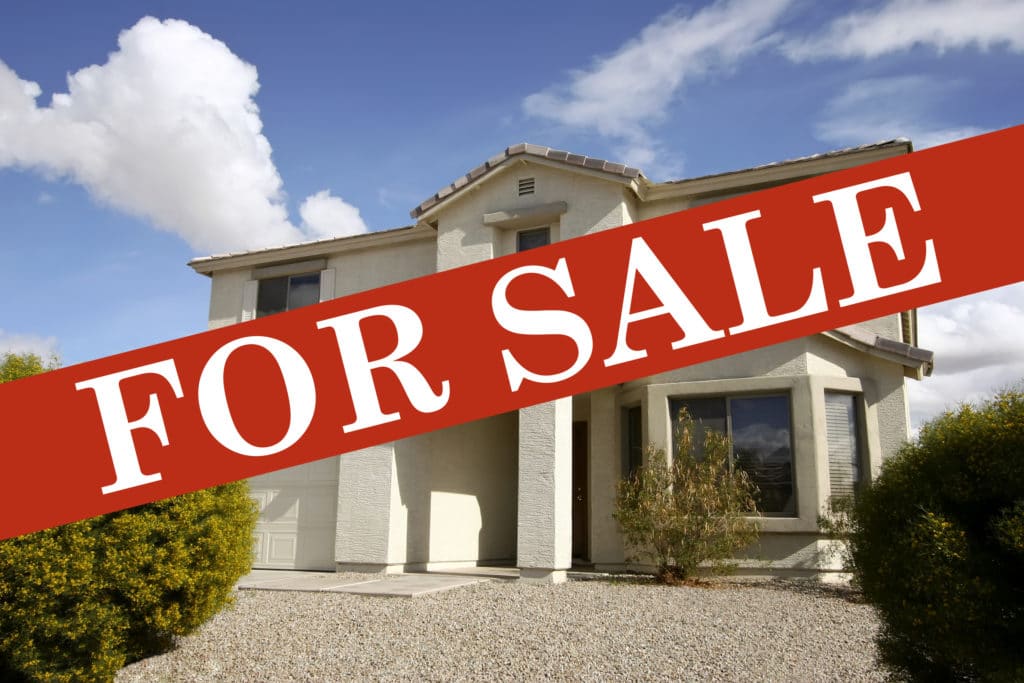 Spacious house with a 'For Sale' sign displayed prominently.