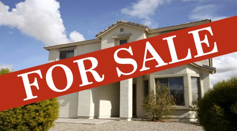 Spacious house with a 'For Sale' sign displayed prominently.