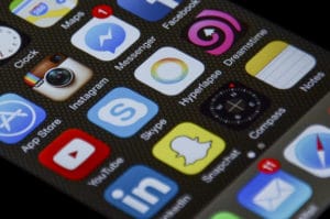 Close-up of a smartphone screen displaying social media and communication app icons.