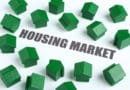 Green house models around 'Housing Market' text.