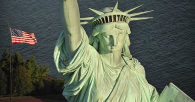 Close-up of the Statue of Liberty's face and crown at dusk.