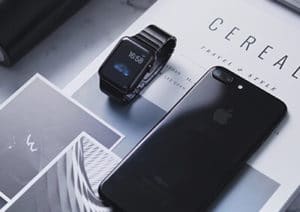 Smartwatch and smartphone on a magazine page.