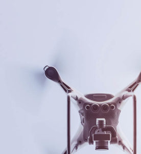 A drone captured from above, showing its propellers and camera.