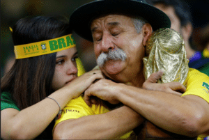 Emotional moment between two people in Brazil fan gear.