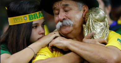 Emotional moment between two people in Brazil fan gear.