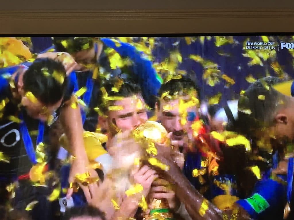 Athletes celebrate victory amid golden confetti.