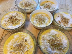 The illuminated facade of Al-Ajami Restaurant at night.