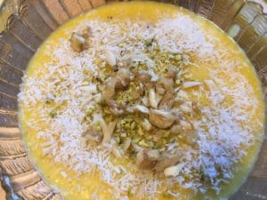 The illuminated facade of Al-Ajami Restaurant at night.