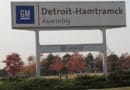 Sign for General Motors Detroit-Hamtramck Assembly plant with fall trees in the background.