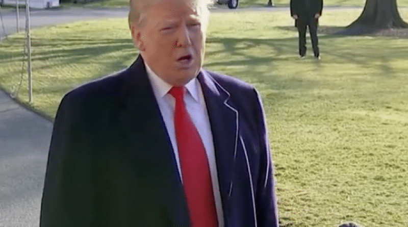 Donald Trump speaking outdoors with microphones in front.