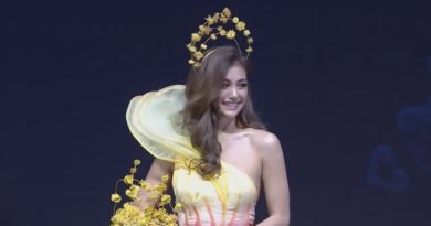 Woman wearing a yellow floral crown and a strapless pastel dress.