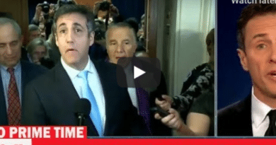 News reporter delivering breaking news with a live camera crew behind.