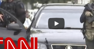 CNN report on New Zealand terrorist attacks with armed police presence.