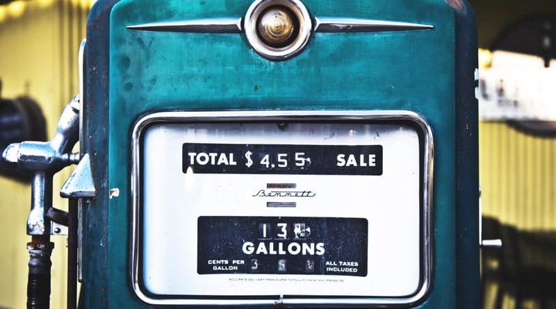 Vintage gas pump showing total sale and gallons dispensed.
