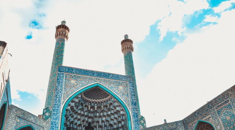 Architectural view of a mosque with blue sky background.