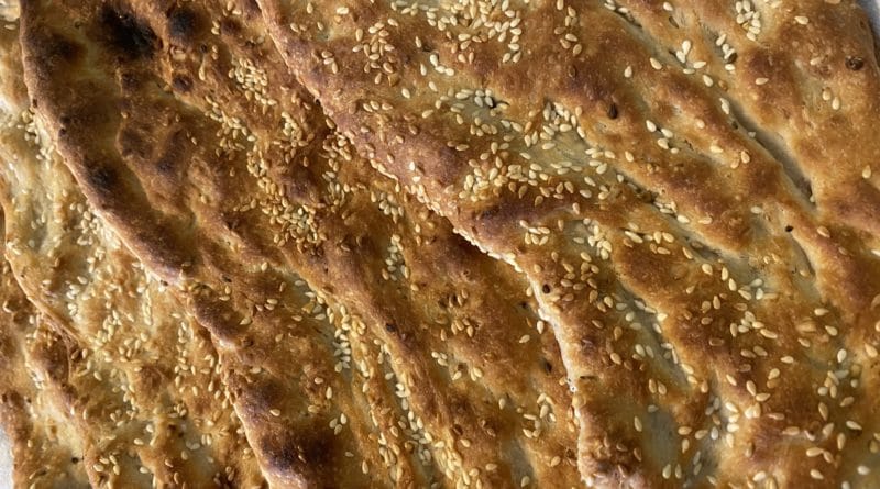 Close-up of textured brown surface with small granular details.