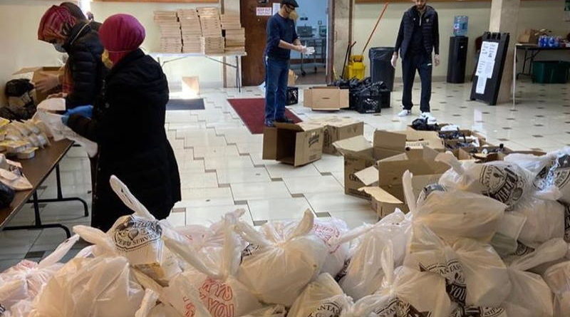 Volunteers organizing food packages for distribution.