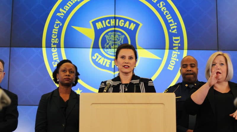 Three officials at a Michigan Department of Homeland Security press conference.