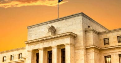 Historic building with flags at sunset under a dramatic sky.