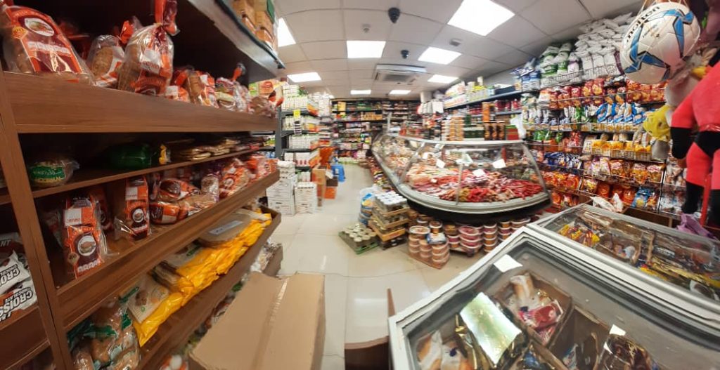 Inside a busy supermarket aisle filled with various food products.