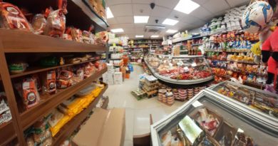Inside a busy supermarket aisle filled with various food products.