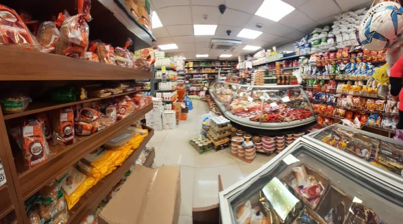 Inside a busy supermarket aisle filled with various food products.