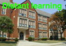 A classic brick school building with green text overlay about distant learning.