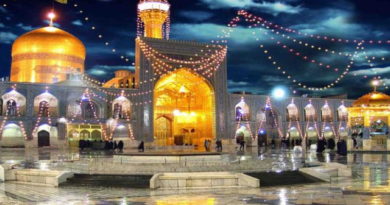 Illuminated mosque courtyard at night under a moonlit sky.